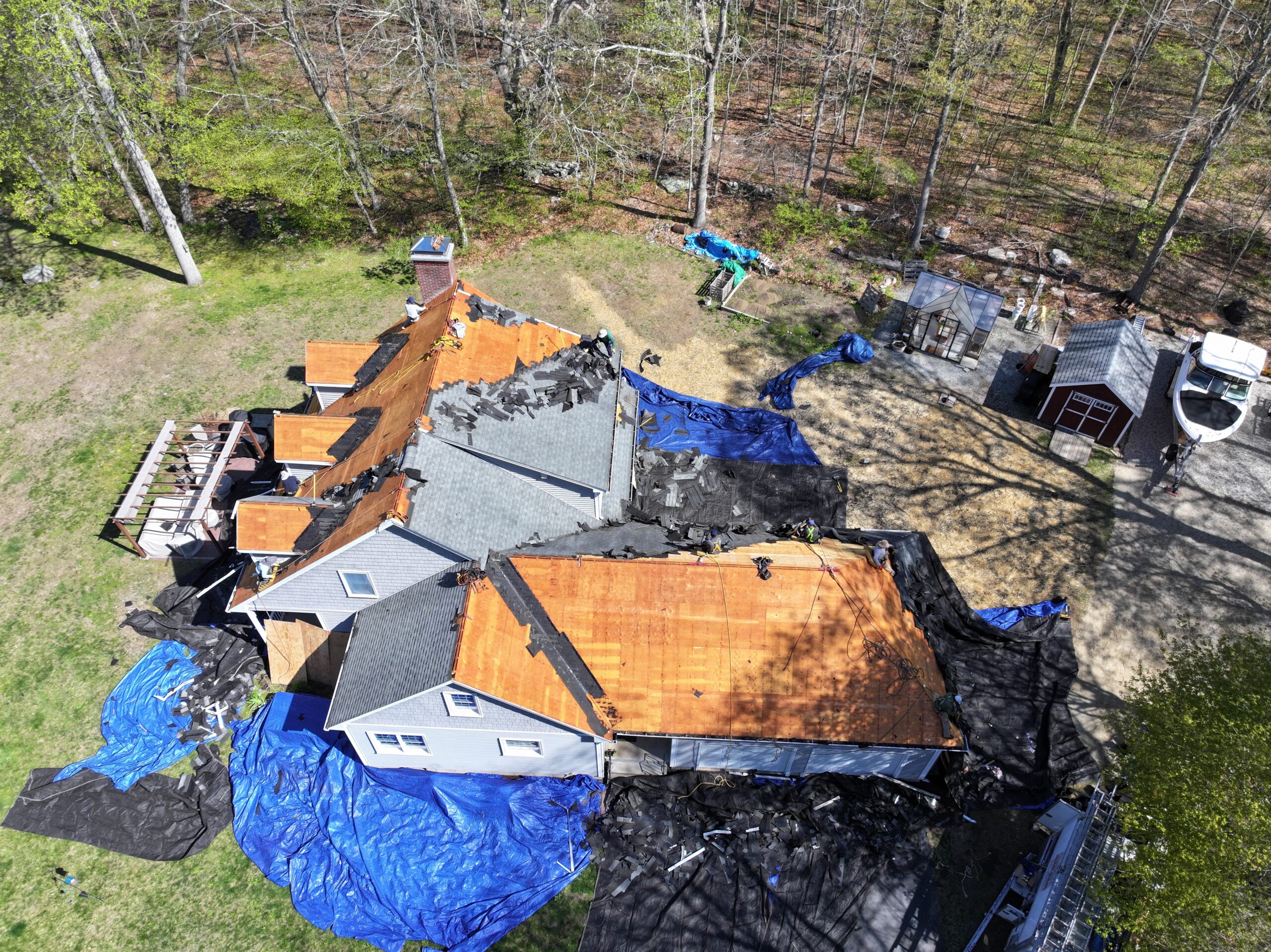 Christopher Home Improvement crew installing a new roof on a Cape-style home